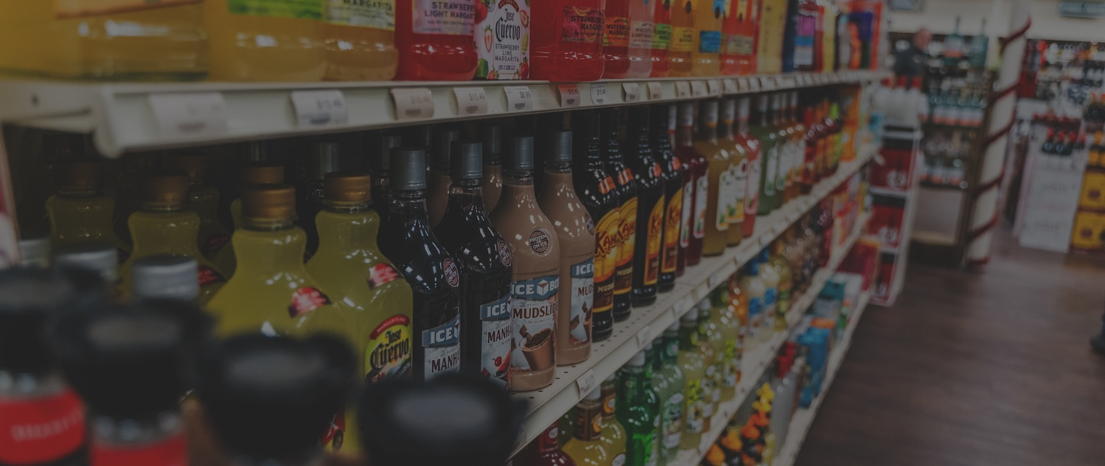 darkened image of liquors on store shelf