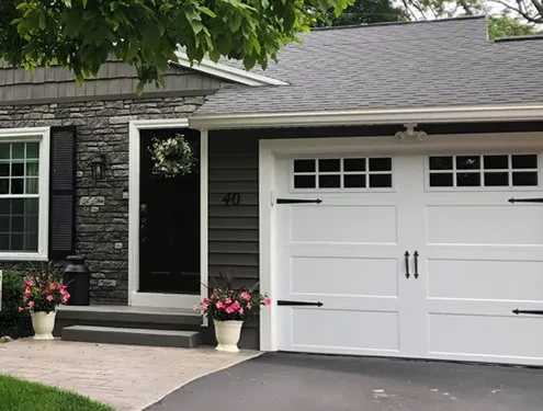 dark gray home with stone work on front wall