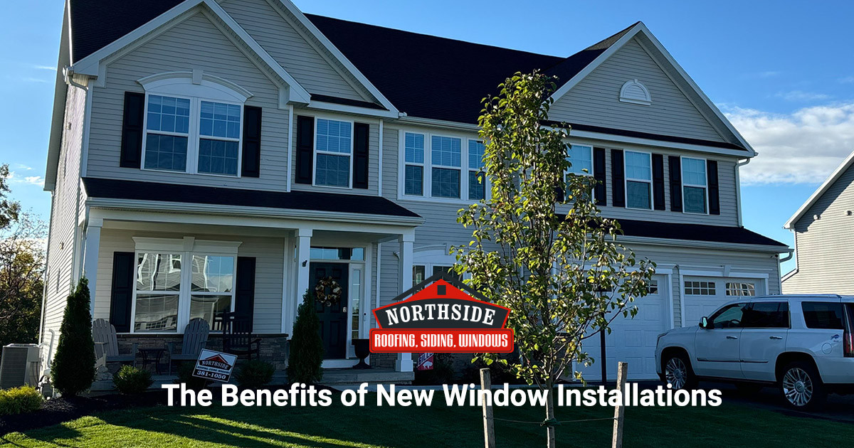 Light tan home with white trim and brown roof "The Benefits of New Window Installations"