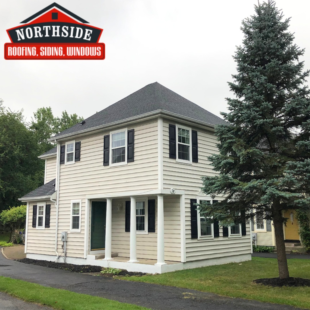 tan house with white trim and gray roof