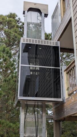 Enclosed Outdoor Elevator at the second story of a three strory house