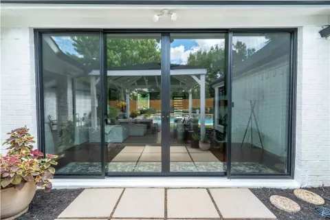 large sliding glass doors reflect an outdoor patio