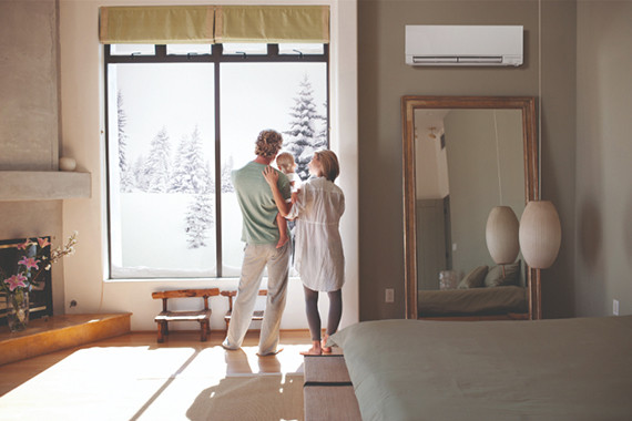 Family enjoying winter in their house with new heating system and furnace