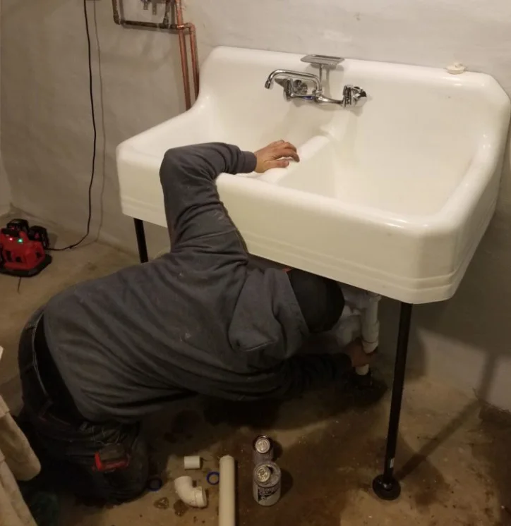 outdoor air conditioning unit surrounded by green bushes