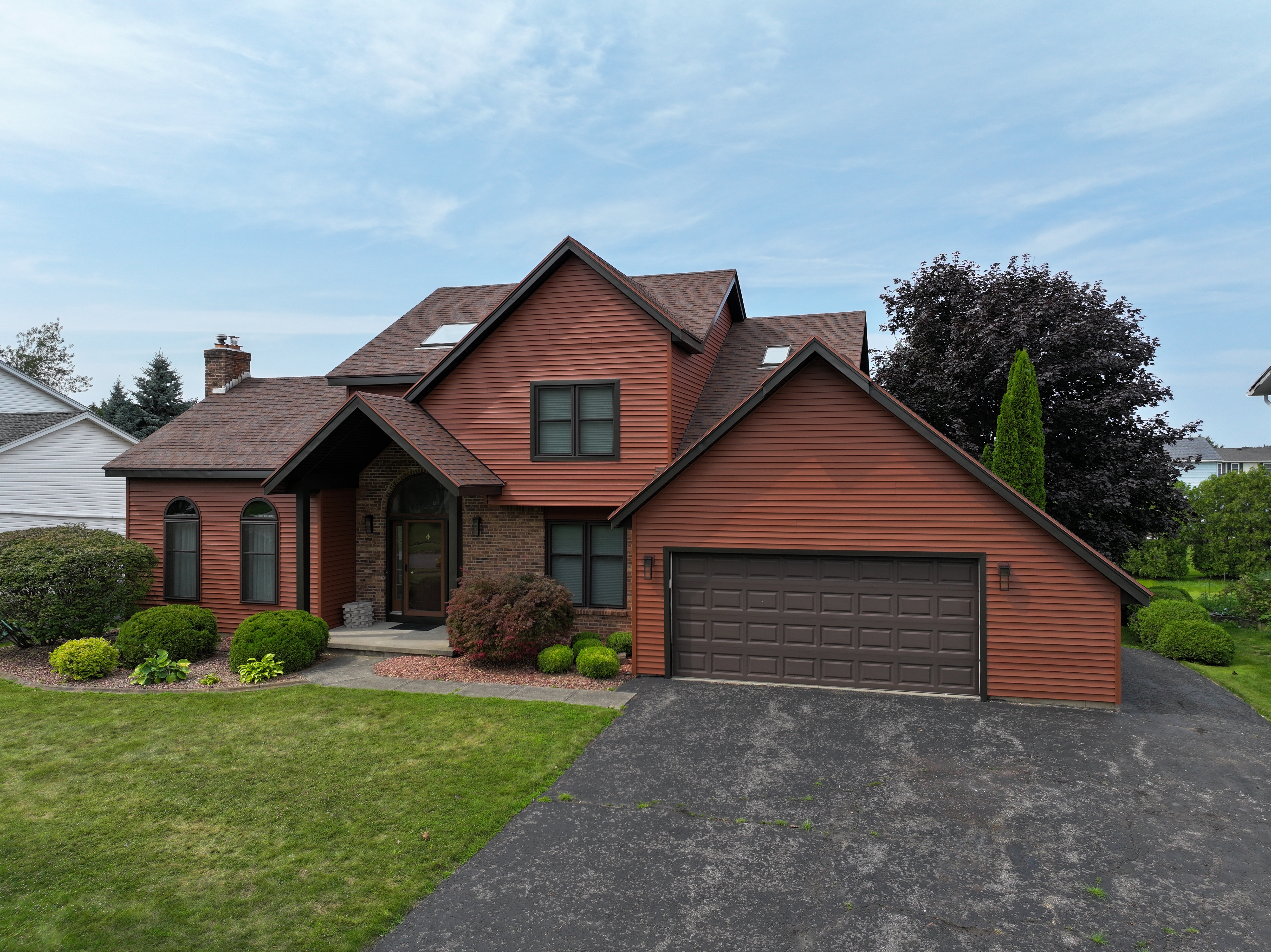 New roofing and siding on a brown house.