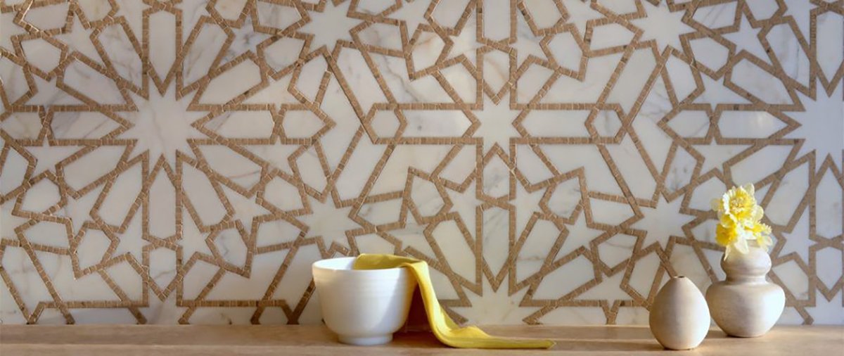 arabesque tile design on a wall with a table and decor in front