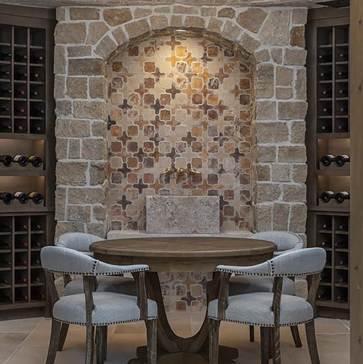 Wine cellar with stone archway and a table with four chairs