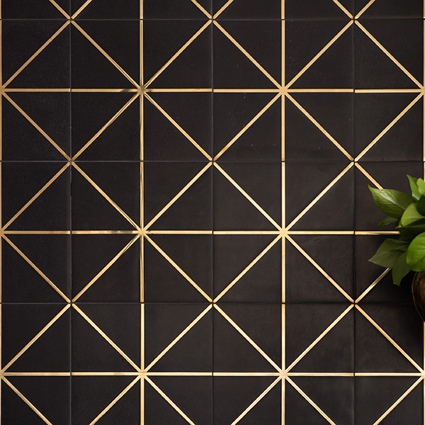 black tile with gold geometric pattern