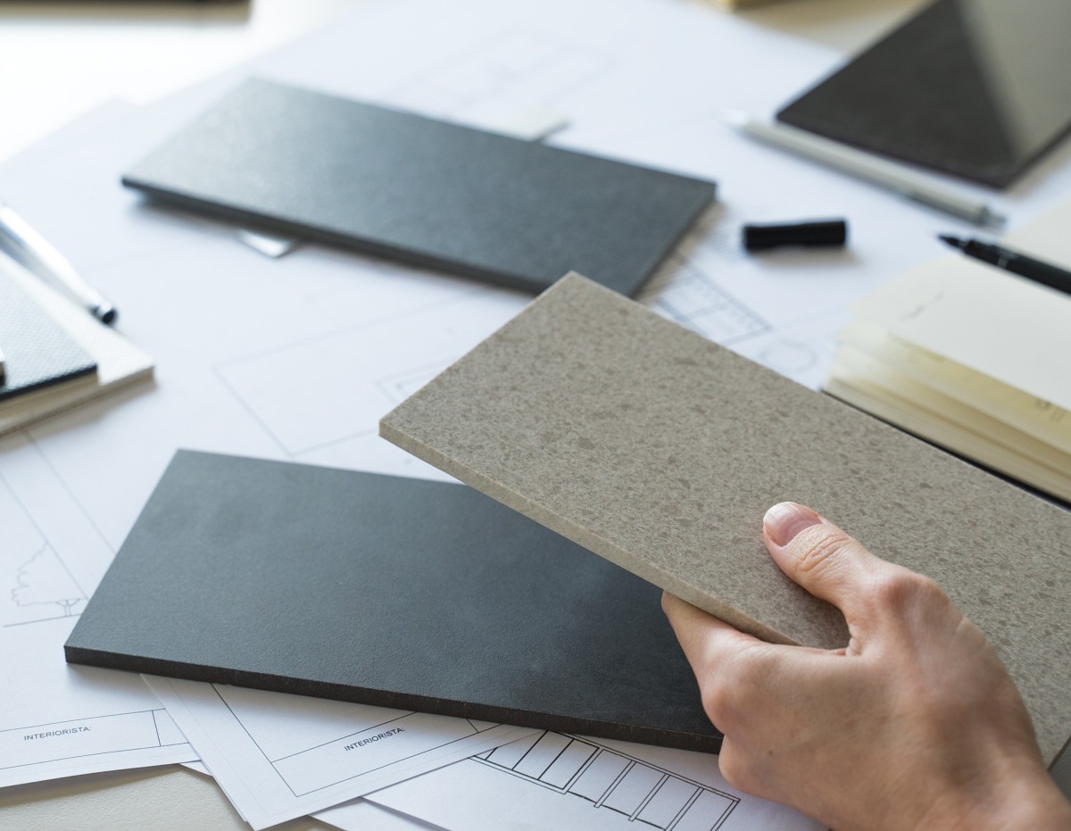two women discussing work at desk with laptop