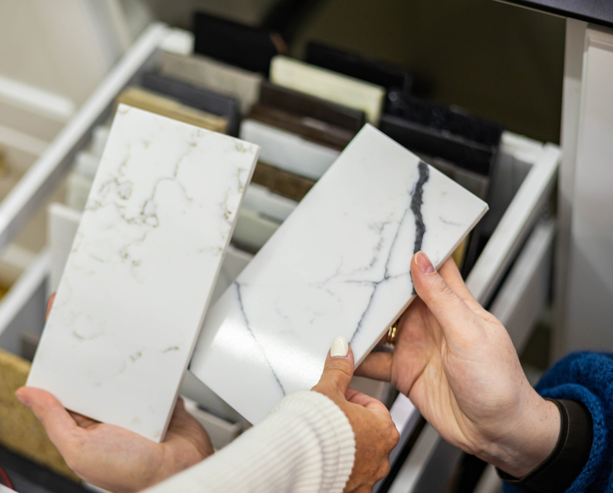 hand grabbing marble tile sample