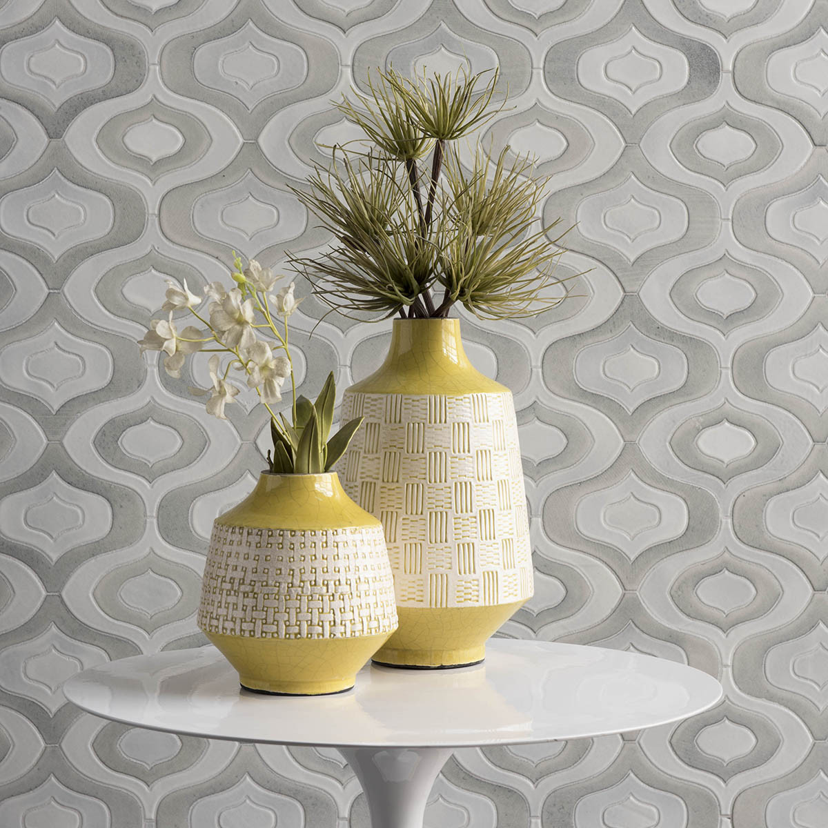gray and white stone tile with yellow vases on table
