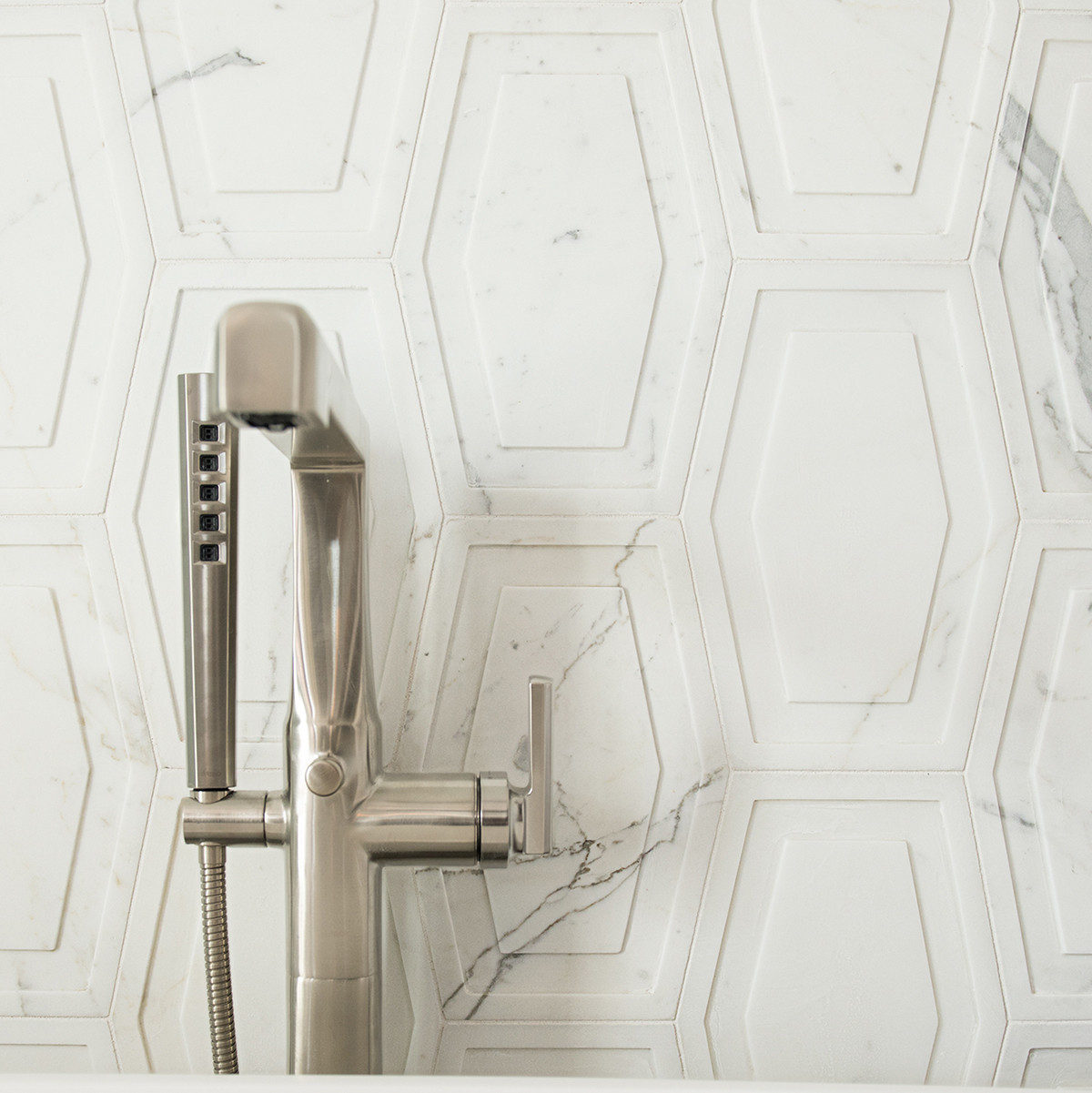 textured marble tile with silver faucet