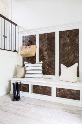 chevron wood tile entryway with pillows and rainboots