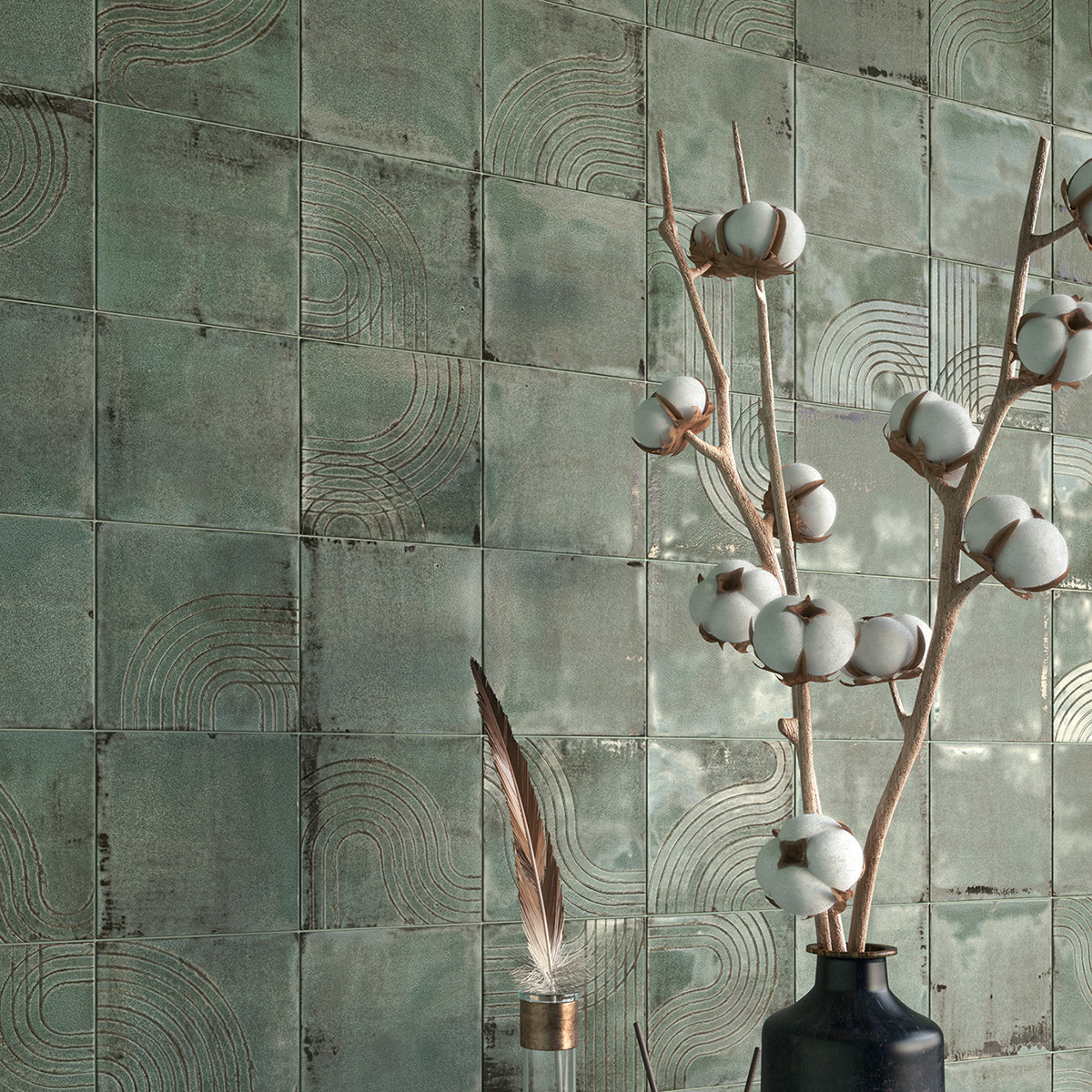 textured green tile wall with cotton branches in vase