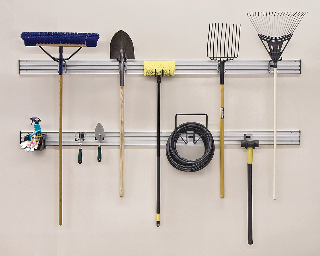 Garden tools, hose, and cleaning supplies neatly hanging on a wall-mounted storage rack.
