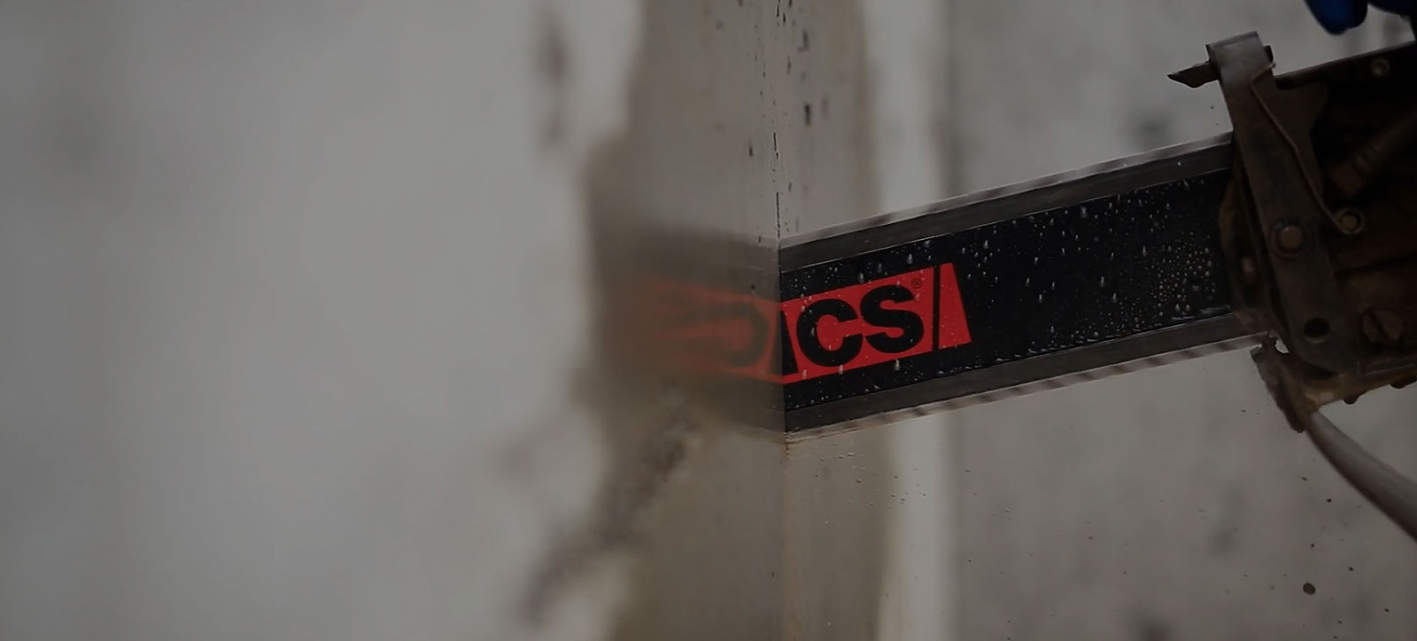 chainsaw cutting through a wall