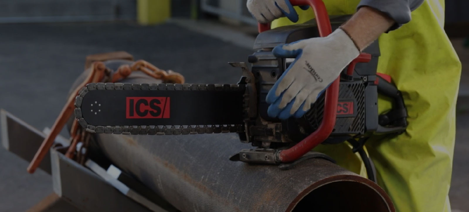 construction worker holding a ICS chainsaw