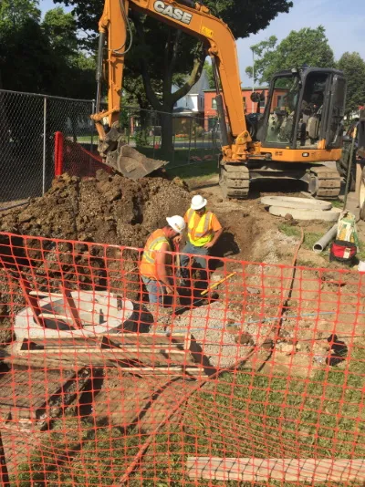 two men working at a dig site
