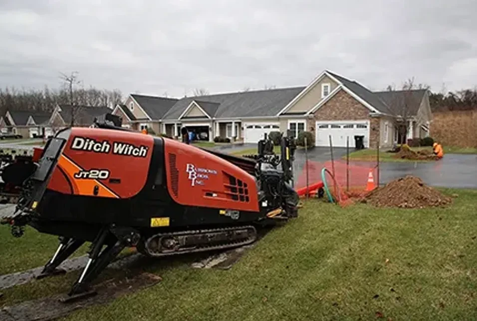 directional drilling ditch witch equipment outside a home