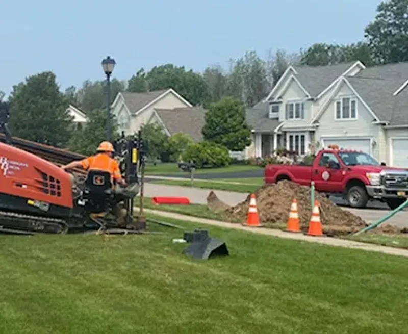 burrows bros digging a trenchless solution in a home yard