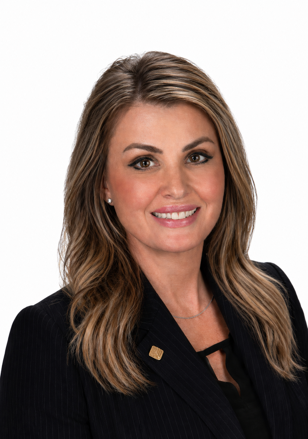 Smiling woman with long brown hair in a black blazer, posing for a professional headshot.