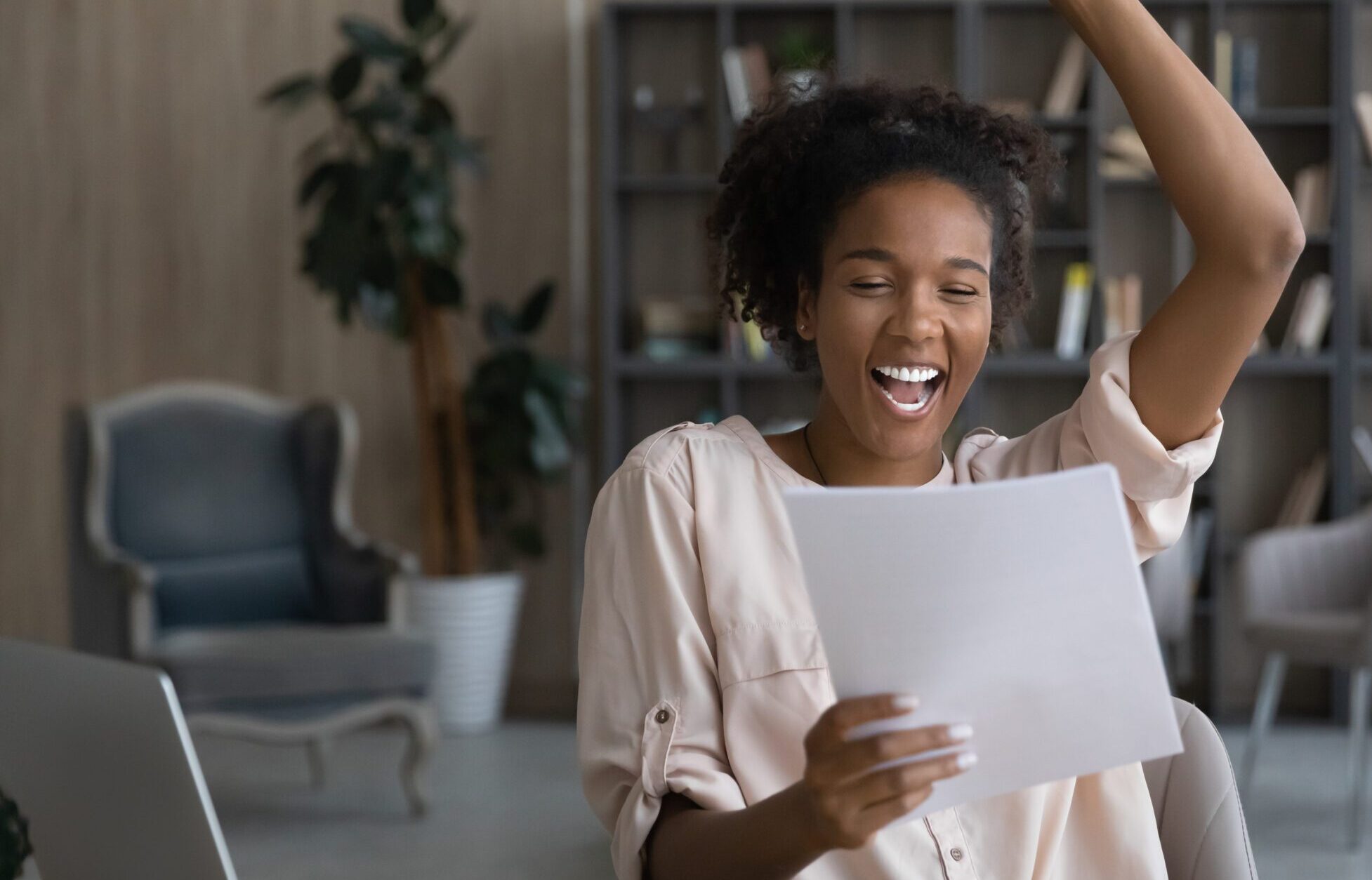 Girl looking at papers and laughing