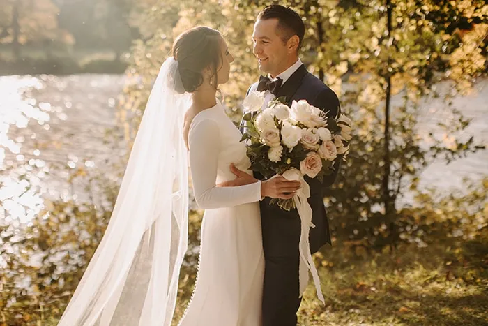Happy couple on their wedding day wearing Adrian Jules custom suits
