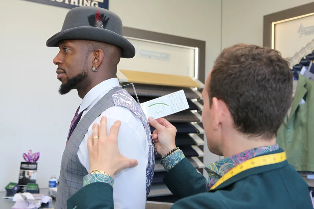Groom getting ready in custom suit