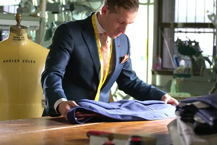 Master tailor crafting a custom wedding suit at Adrian Jules