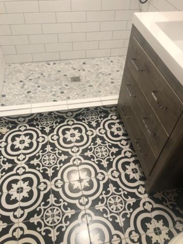 bold tile in renovated bathroom floor and shower