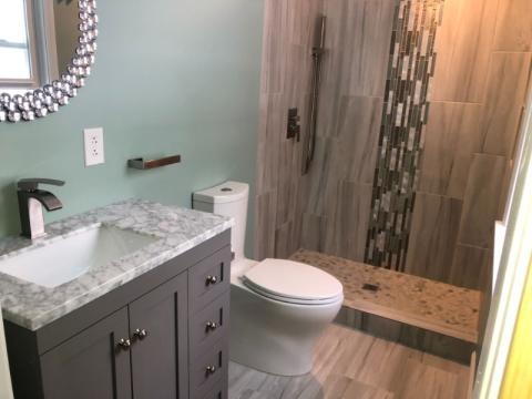 after bathroom renovation with updated tile paint and design