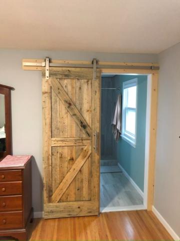 sliding barn door made of light colored wood