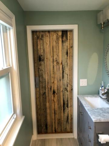 beautiful wood door in renovated bathroom