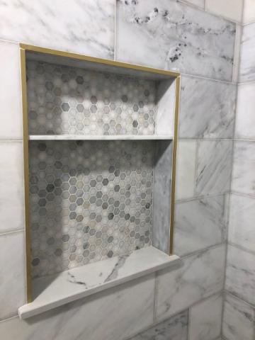 white marble and tiled bathroom shower