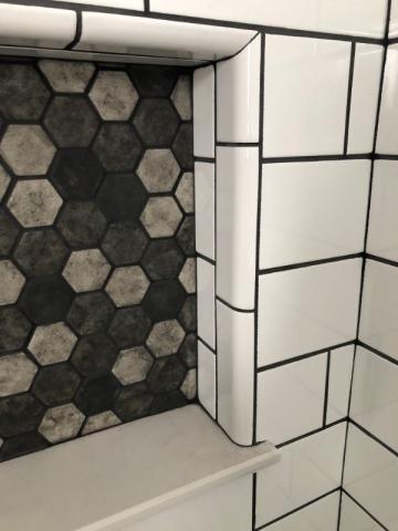 close up of subway tile and accent tile in shower