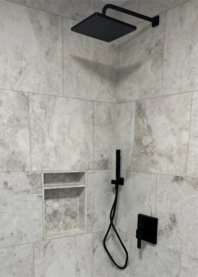 gray tiled bathroom with dark brown waterfall features
