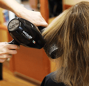 animated gif of a hair dresser blow drying a client's hair