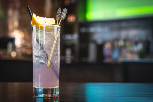 refreshing cocktail topped with a lemon