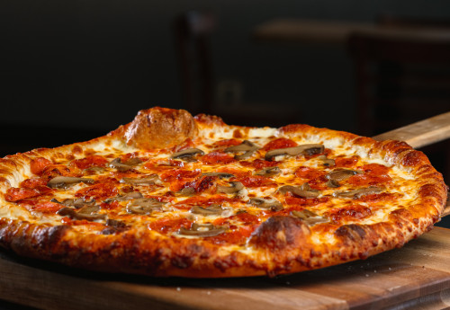 fresh out of the oven pepperoni and mushroom pizza