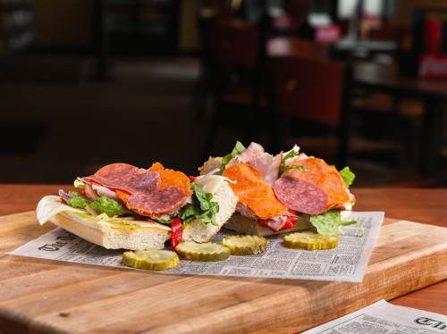 italian sub served with pickle chips