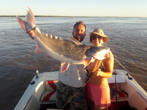 couple posing with fish