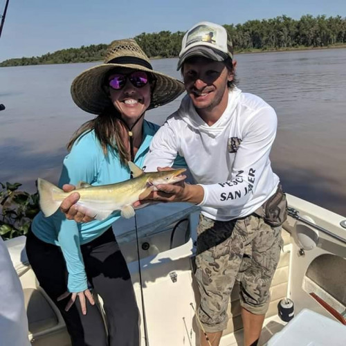 couple holding a fish