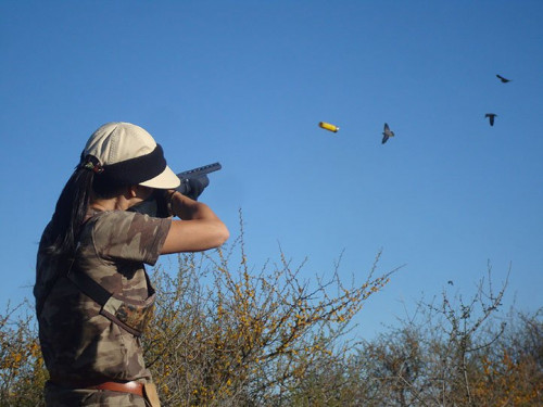 woman shooting at bird