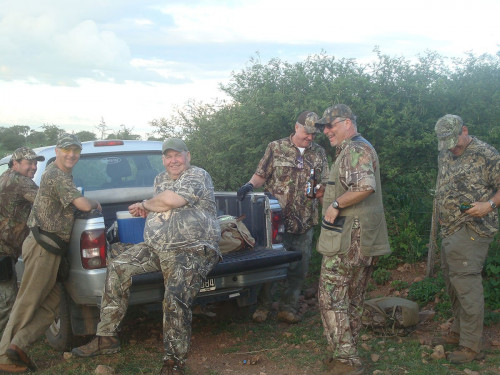 6 men in hunting gear