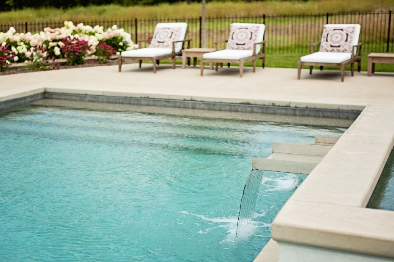 close up of steps into the pool with waterfall feature