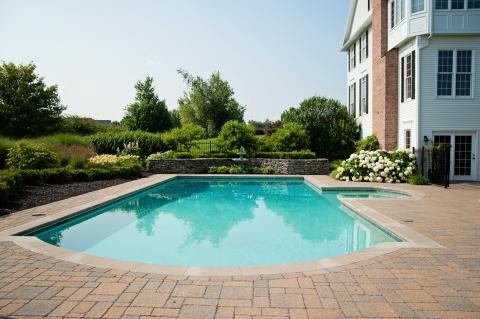 wide shot of aqua pool with concrete pool deck