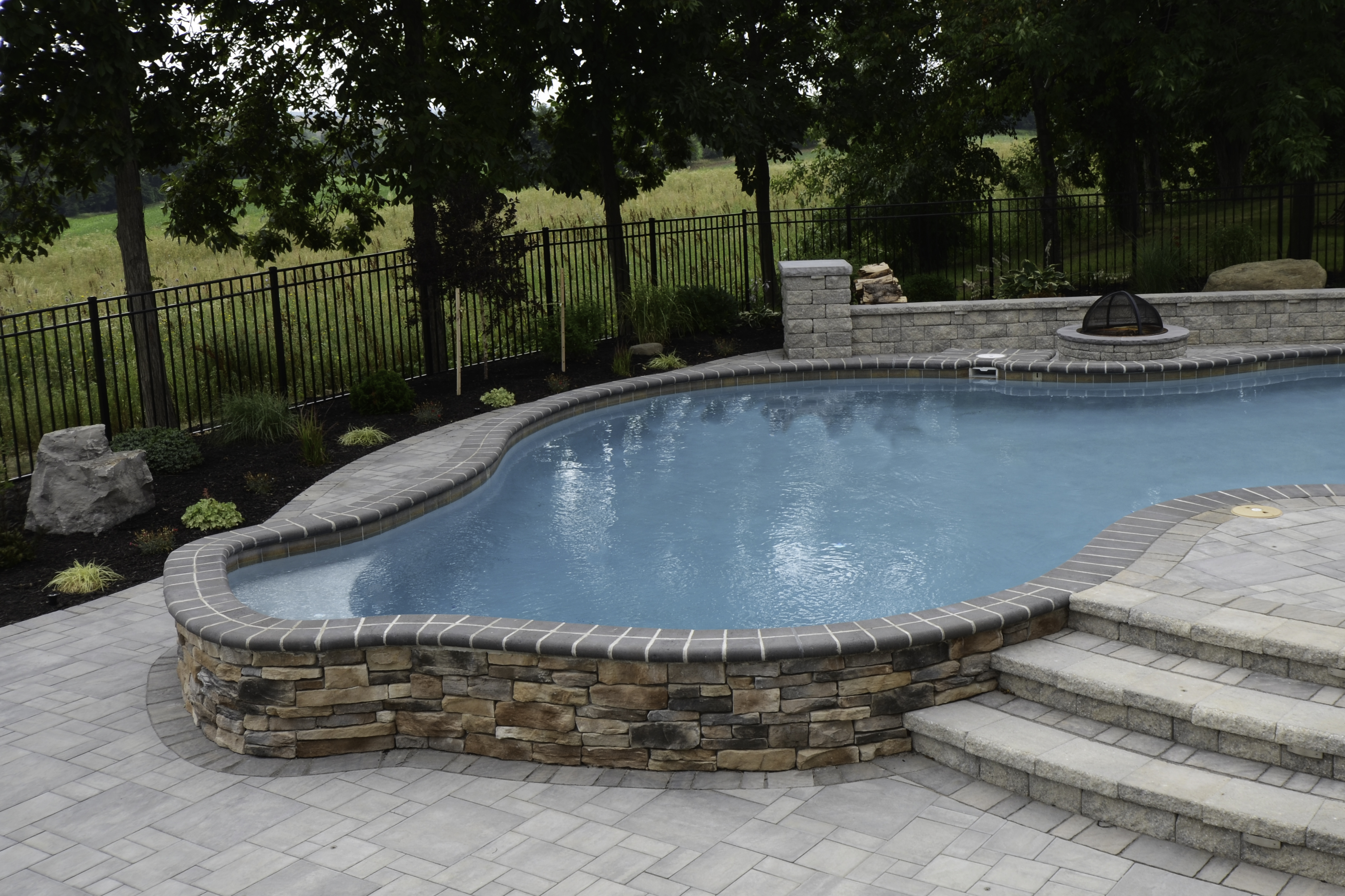 custom outdoor residential pool with stone pool deck