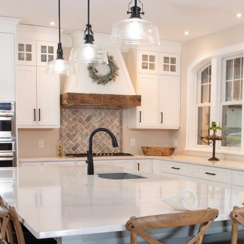 kitchen with beautiul black faucet and charming cabinetry