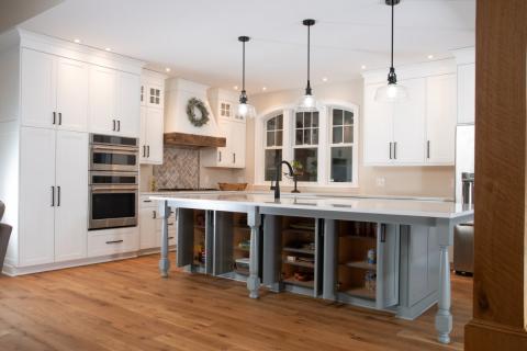 another view of white and gray island with open cabinets