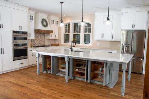 white and gray island showing open cabinets